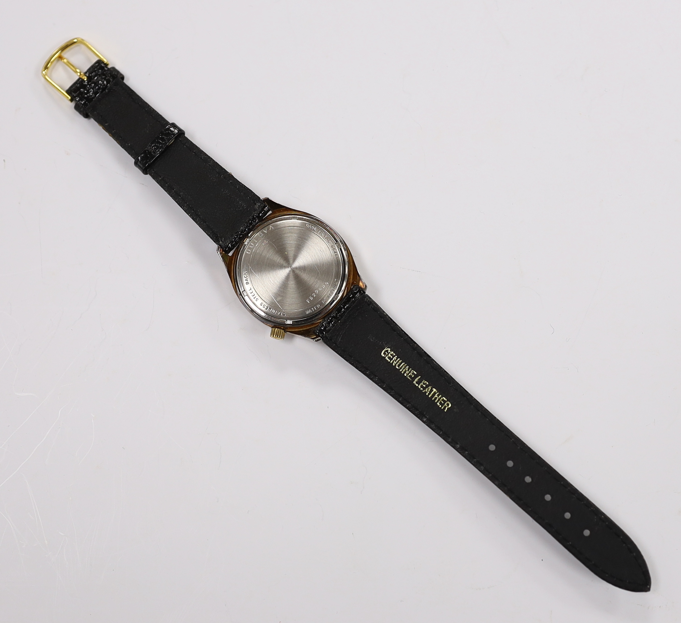A gentleman's stainless steel and base metal Bulova Accutron wrist watch, with two tone dial, on a leather strap, case diameter 34mm.